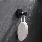 Suction wall hook on a dark stone wall