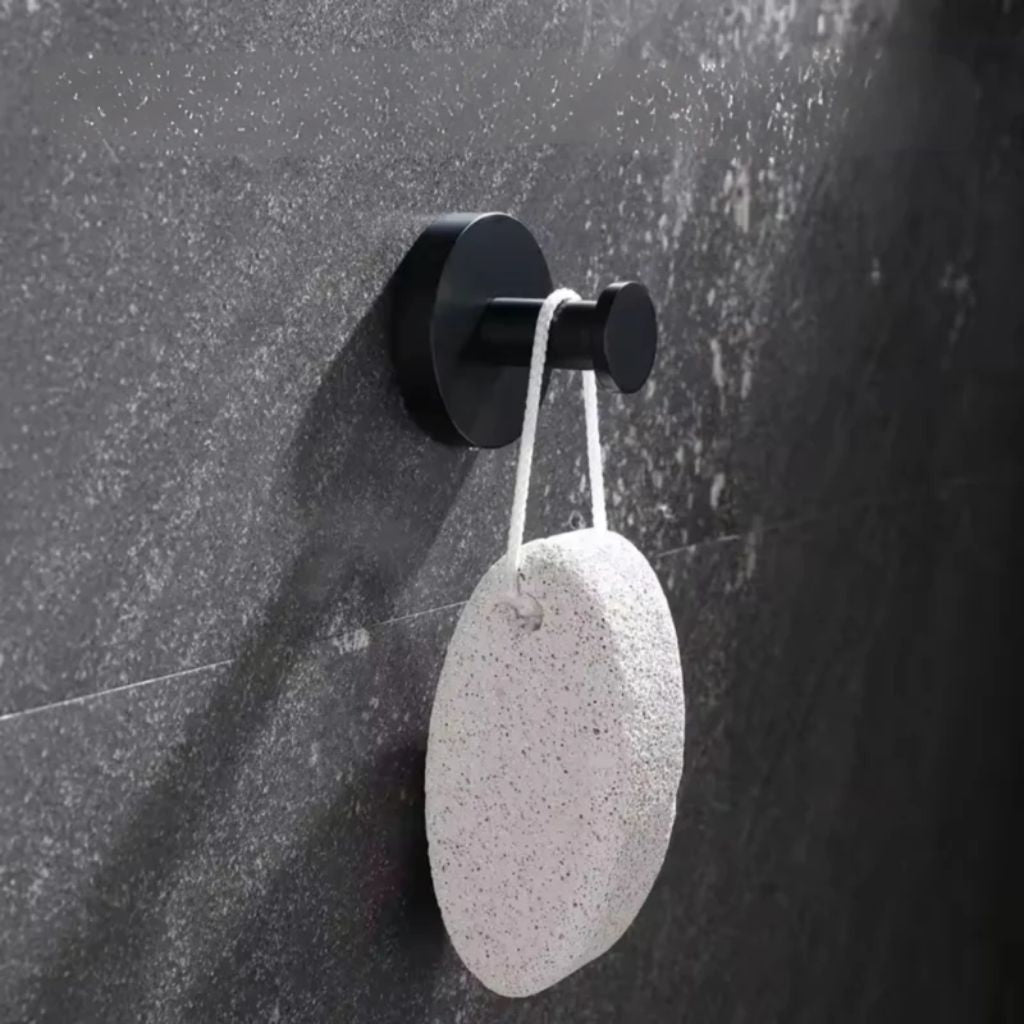 Suction wall hook on a dark stone wall