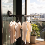 Suction clothes hanger drying t-shirts on an apartment balcony door
