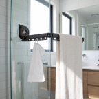 Suction clothes hanger on a glass shower screen holding towels