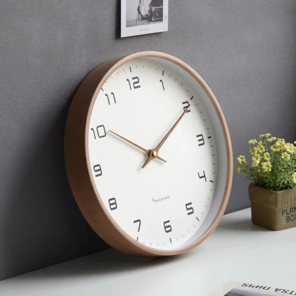 Wooden wall clock leaning on a desk